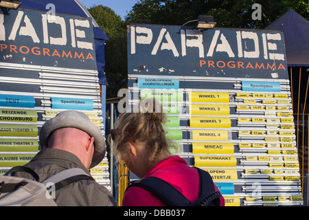 People searching the program of theater festival the Parade Stock Photo