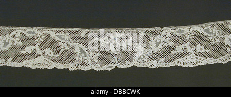 A delicate lace fabric features intricate patterns and cut-outs ...