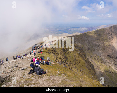 People walking on Llanberis path near Mount Snowdon summit on a busy summer bank holiday weekend in Snowdonia, Wales, UK Stock Photo