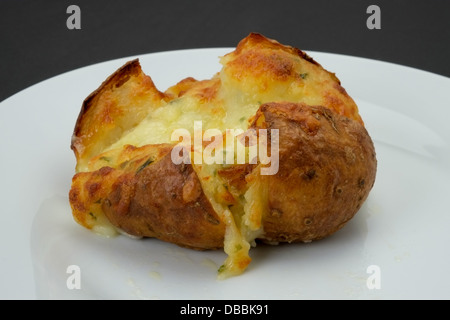 Baked jacket potato filled with cheese - studio shot Stock Photo