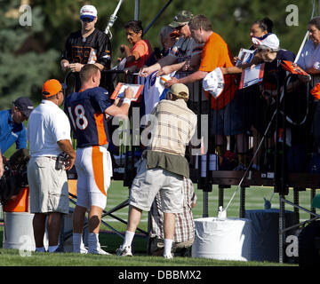 Englewood, Colorado, USA. 27th July, 2013. Denver Broncos QB PEYTON MANNING, left, signs autographs for lucky fans before the start of drills during Training Camp at Dove Valley Saturday Morning. Credit:  Hector Acevedo/ZUMAPRESS.com/Alamy Live News Stock Photo