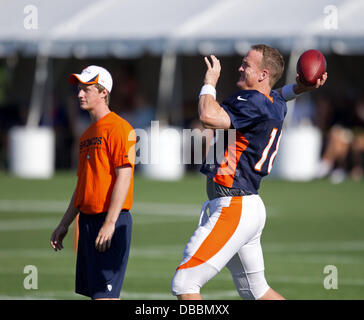 Englewood, Colorado, USA. 27th July, 2013. Denver Broncos QB PEYTON MANNING, right, warms up before the start of drills during Training Camp at Dove Valley Saturday Morning. Credit:  Hector Acevedo/ZUMAPRESS.com/Alamy Live News Stock Photo