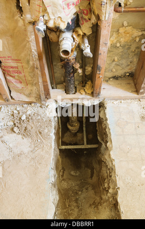 exposed water and drain pipes during home plumbing renovation Stock Photo