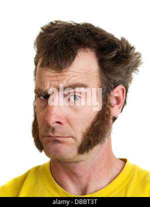 a man with large sideburns looks at the camera with one eyebrow raised Stock Photo