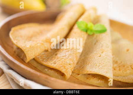 Close up Asian style breakfast homemade banana pancakes or crepe on dining table. Stock Photo