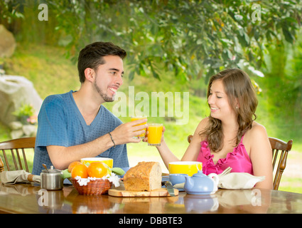 couple having breakfast at home with garden in the background Stock Photo