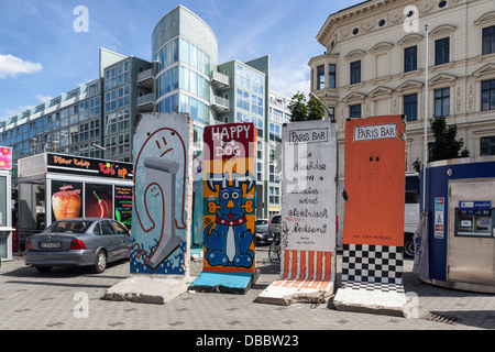 Painted pieces of the Berlin wall at Checkpoint Charlie Border post, Friederichstrasse, Berlin Stock Photo