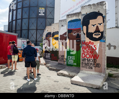 Berlin wall pieces decorated with pictures of present day leaders - Checkpoint Charlie Border border post, Friederichstrasse, Berlin Stock Photo