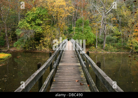 A Wooden Foot Bridge Over The Little Miami River In Autumn, John Bryan State Park, Southwestern Ohio, USA Stock Photo