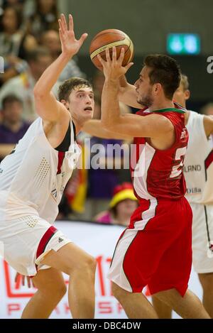 Goettingen, Germany. 27th July, 2013. Germany's Tibor Pleiss (L) plays against Portugal's Tomas Barroso during the international basketball match Germany vs. Portugal at S-Arena in Goettingen, Germany, 27 July 2013. Photo: Swen Pfoertner/dpa/Alamy Live News Stock Photo