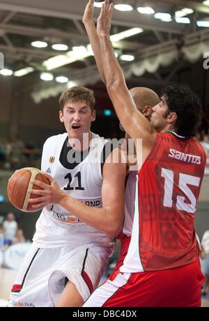 Goettingen, Germany. 27th July, 2013. Tibor Pleiss (L) plays against Portugal's Joao Santos during the international basketball match Germany vs. Portugal at S-Arena in Goettingen, Germany, 27 July 2013. Photo: Swen Pfoertner/dpa/Alamy Live News Stock Photo