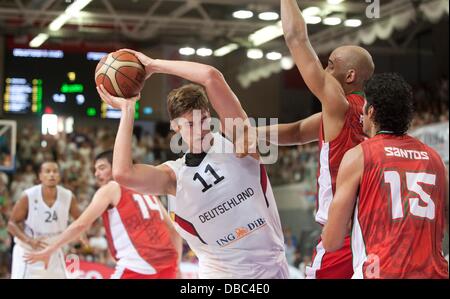 Goettingen, Germany. 27th July, 2013. Tibor Pleiss (L) plays against Portugal's Claudio Fonseca and Joao Santos during the international basketball match Germany vs. Portugal at S-Arena in Goettingen, Germany, 27 July 2013. Photo: Swen Pfoertner/dpa/Alamy Live News Stock Photo