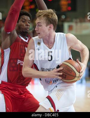 Goettingen, Germany. 27th July, 2013. Germany's Niels Giffey (R) plays against Portugal's Carlos Andrade during the international basketball match Germany vs. Portugal at S-Arena in Goettingen, Germany, 27 July 2013. Photo: Swen Pfoertner/dpa/Alamy Live News Stock Photo