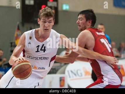 Goettingen, Germany. 27th July, 2013. Germany's Andreas Seifferth (L) plays against Portugal's Miguel Miranda during the international basketball match Germany vs. Portugal at S-Arena in Goettingen, Germany, 27 July 2013. Photo: Swen Pfoertner/dpa/Alamy Live News Stock Photo