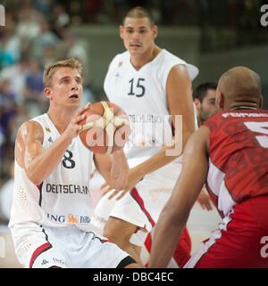 Goettingen, Germany. 27th July, 2013. Germany's Heiko Schaffartzik (L) plays against Portugal's Claudio Fonseca during the international basketball match Germany vs. Portugal at S-Arena in Goettingen, Germany, 27 July 2013. Photo: Swen Pfoertner/dpa/Alamy Live News Stock Photo