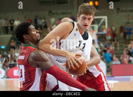 Goettingen, Germany. 27th July, 2013. Germany's Tibor Pleiss (L) plays against Portugal's Carlos Andrade during the international basketball match Germany vs. Portugal at S-Arena in Goettingen, Germany, 27 July 2013. Photo: Swen Pfoertner/dpa/Alamy Live News Stock Photo