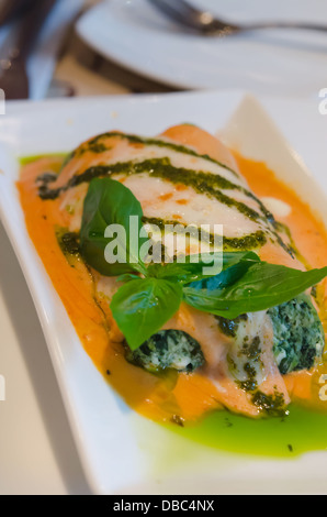 Baked Lasagna Rolled With Spinach Ricotta Cream Topped With Sweet Capsicum & Pesto Sauce Stock Photo