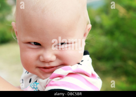 Funny smiling baby girl outdoor summer closeup portrait Stock Photo