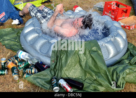 Paaren im Glien, Germany. 27th July, 2013. Paul throws himself into a small pool at the Greenville Festival in Paaren im Glien, Germany, 27 July 2013. The music festival is featured between 26. and 28 July 2013 near Berlin. Photo: Britta Pedersen/dpa/Alamy Live News Stock Photo