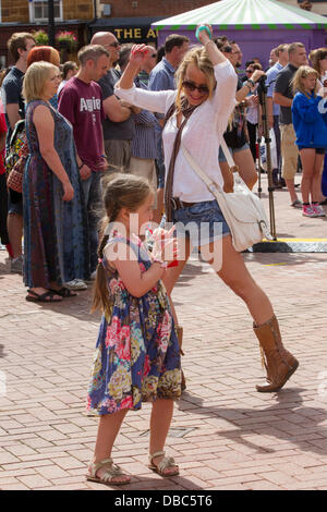 Northampton, UK. 28th July, 2013. Northampton's 7th Music Festival underway. 5 stages are set up around the town to showcase local musicians,  they started playing at midday and goes on goes on until 2200 hrs. This is the Market Square were the main stage is with crowds enjoying the music and good weather. Credit:  Keith J Smith./Alamy Live News Stock Photo