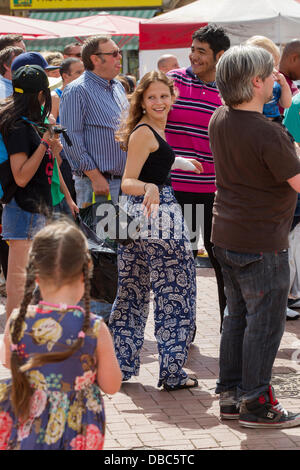 Northampton, UK. 28th July, 2013. Northampton's 7th Music Festival underway. 5 stages are set up around the town to showcase local musicians,  they started playing at midday and goes on goes on until 2200 hrs. This is the Market Square were the main stage is with crowds enjoying the music and good weather. Credit:  Keith J Smith./Alamy Live News Stock Photo