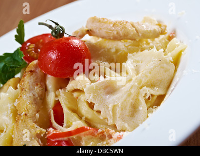 Farfalle pasta with cream sauce and tomatoes Stock Photo