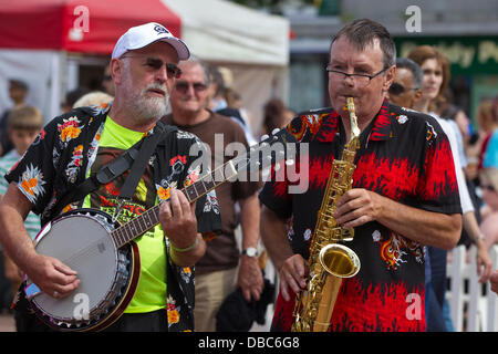 Northampton, UK. 28th July, 2013. Northampton's 7th Music Festival underway. 5 stages are set up around the town to showcase local musicians,  they started playing at midday and goes on goes on until 2200 hrs. This is the Market Square were the main stage is with crowds enjoying the music and good weather. Credit:  Keith J Smith./Alamy Live News Stock Photo