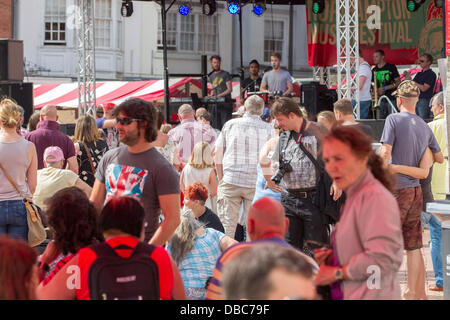 Northampton, UK. 28th July, 2013. Northampton's 7th Music Festival underway. 5 stages are set up around the town to showcase local musicians,  they started playing at midday and goes on goes on until 2200 hrs. This is the Market Square were the main stage is with crowds enjoying the music and good weather. Credit:  Keith J Smith./Alamy Live News Stock Photo