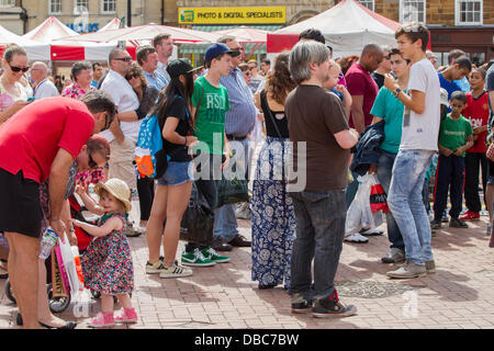 Northampton, UK. 28th July, 2013. Northampton's 7th Music Festival underway. 5 stages are set up around the town to showcase local musicians,  they started playing at midday and goes on goes on until 2200 hrs. This is the Market Square were the main stage is with crowds enjoying the music and good weather. Credit:  Keith J Smith./Alamy Live News Stock Photo