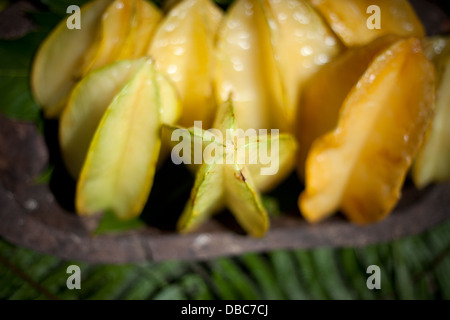 Star Fruit or Carambola in wooden bowl for sale at an organic fruit market in Aitutaki island, Cook Island Stock Photo