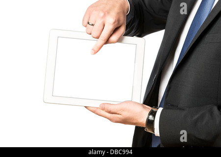 Business man in black suit shows something on his tablet computer, isolated on white background Stock Photo
