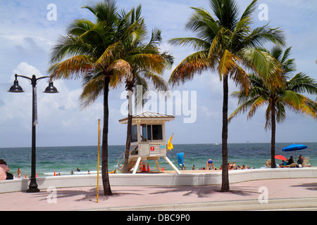 Fort Ft. Lauderdale Florida,South Fort Lauderdale Beach Boulevard,A1A,sunbathers,Atlantic Ocean water,sand,palm trees,seawall,sea wall,lifeguard stati Stock Photo