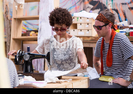 Malmesbury, UK. 28th July, 2013. People take part in a sewing workshop at WOMAD festival in Charlton Park near Malmesbury in Wiltshire. The world music festival attracts nearly 40,000 people to the rural location. Credit:  Adam Gasson/Alamy Live News