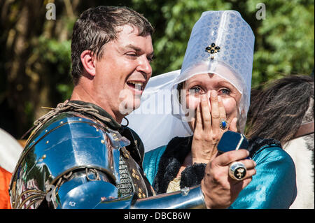 Surprise engagement at the joust and more proof that chivalry is alive and well - after the English win at the International Joust Tournament at Arundel Castle Lord Edward Stacy [Stacy Evans] proposes to his love Lady Elizabeth [Kyle van Dolah] and is accepted to the delight of spectators and the Destrier Pro company.  The week long tournament at Arundel Castle ended with England held on to win victory over the Holy Roman Empire. The riders of Destrier Pro competed for honours and a prize purse of £1500. Stock Photo