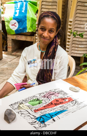 Artist Muhsana Ali with Work of Husband Amadou Kane Sy at Biannual Arts Festival, Goree Island, Senegal. Stock Photo