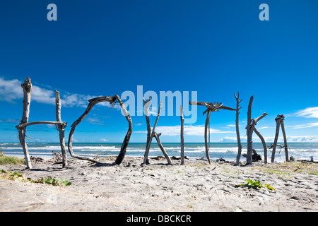 Hokitika. Driftwood sculpture; town name sign sculpted from found drift wood on Hokitika Beach, South Island, New Zealand Stock Photo