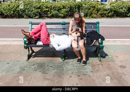 Young couple on a bench, Brighton, England, UK. Stock Photo