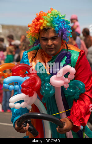 Swanage, Dorset UK 28 July 2013. Thousands of visitors descend on Swanage to watch the procession, as part of Swanage Carnival week. Balloon seller vendor selling modelling balloons. Credit:  Carolyn Jenkins/17�Թ����� Live News Stock Photo