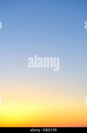 Sky gradient from blue to orange sunset Stock Photo