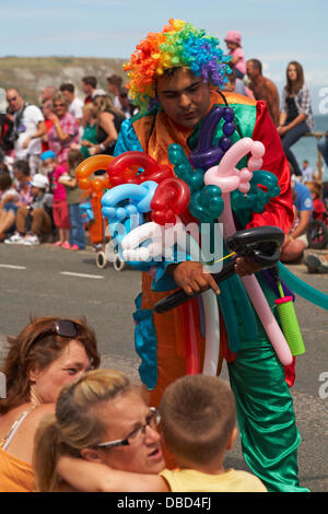 Swanage, Dorset UK 28 July 2013. Thousands of visitors descend on Swanage to watch the procession, as part of Swanage Carnival week. Balloon seller vendor selling modelling balloons. Credit:  Carolyn Jenkins/Alamy Live News Stock Photo