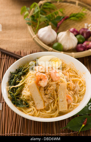 Prawn mee, prawn noodles. Famous Malaysian food spicy fresh cooked har mee in clay pot with hot steam. Stock Photo