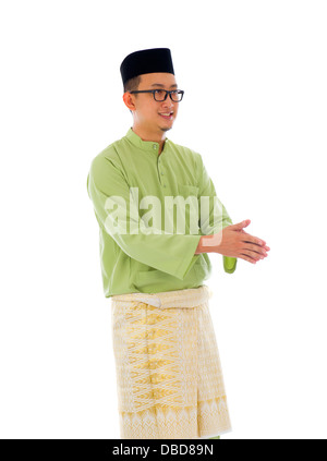 Malay male greetings during ramadan festival with isolated white background Stock Photo