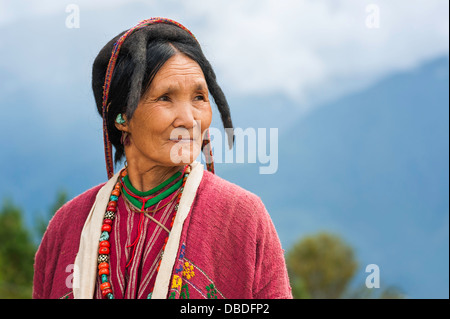 A woman from the Monpa tribe wearing a traditional yak hair  hat at the Buddhist monastery at Tawang, Arunachal Pradesh, India. Stock Photo