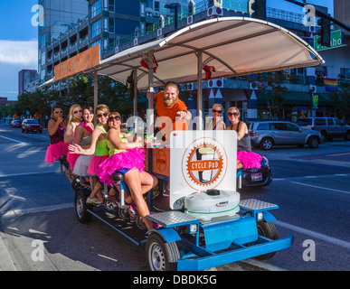 Young women on a cyclepub.com party bike, W Idaho Street in downtown Boise, Idaho, USA Stock Photo