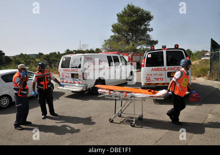 Wounded people being treated by first aid crew Stock Photo