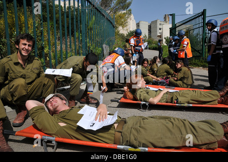 Wounded people being treated by first aid crew Stock Photo