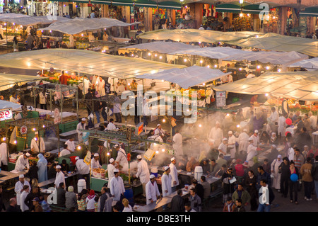 Overlooking busy alfresco food stalls in Djemaa el-Fna square at dusk, Marrakech, Morocco Stock Photo