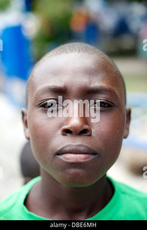 A young boy hangs out outside of the Petionville police station in Port au Prince, Haiti Stock Photo