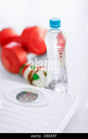 scales, dumbbells, bottle of water, measuring tape Stock Photo