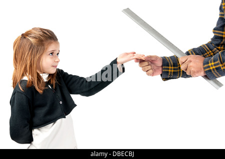 Young girl being physically punished by teacher with a ruler Stock Photo